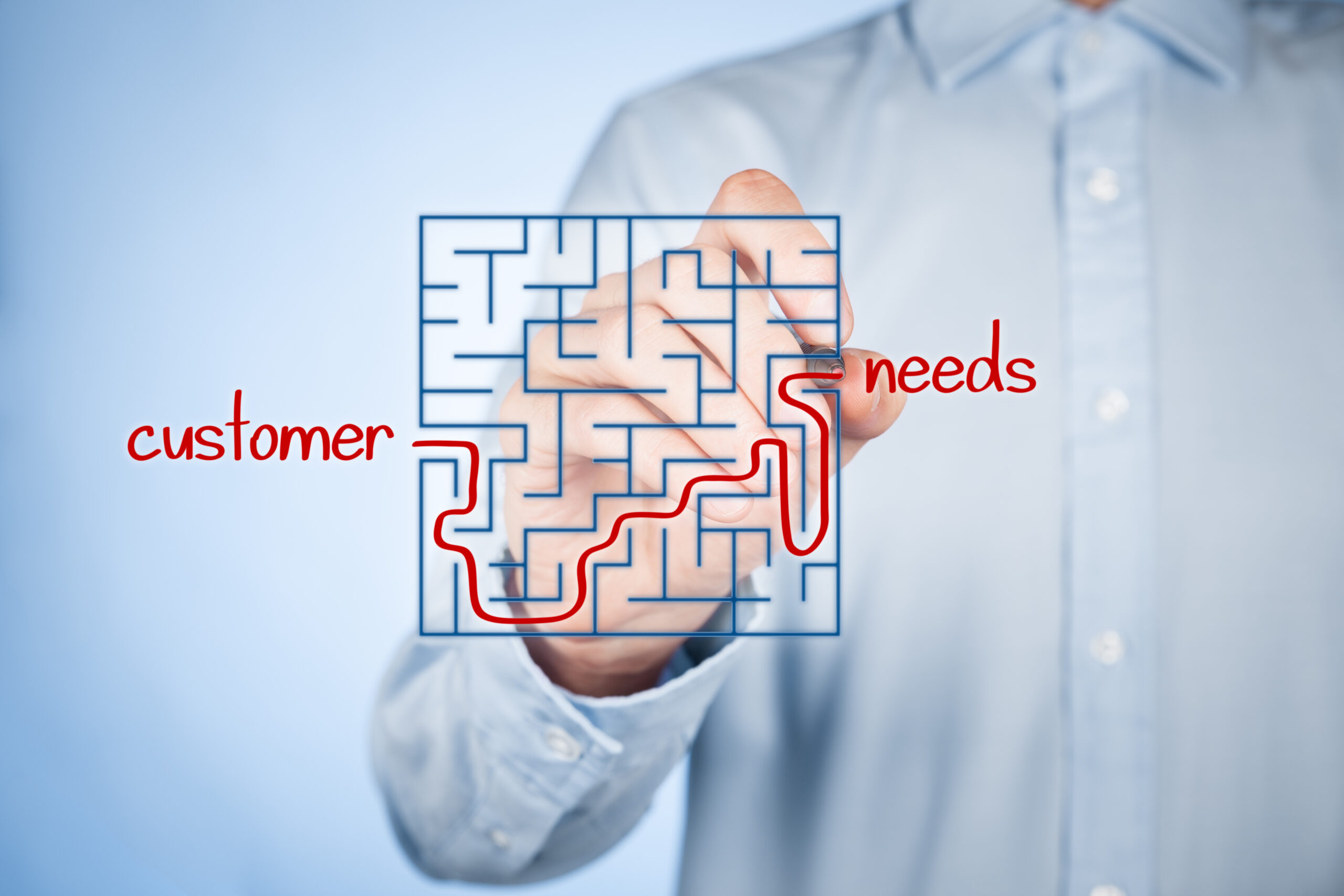 Man connecting the words "customer" and "needs" in a puzzle