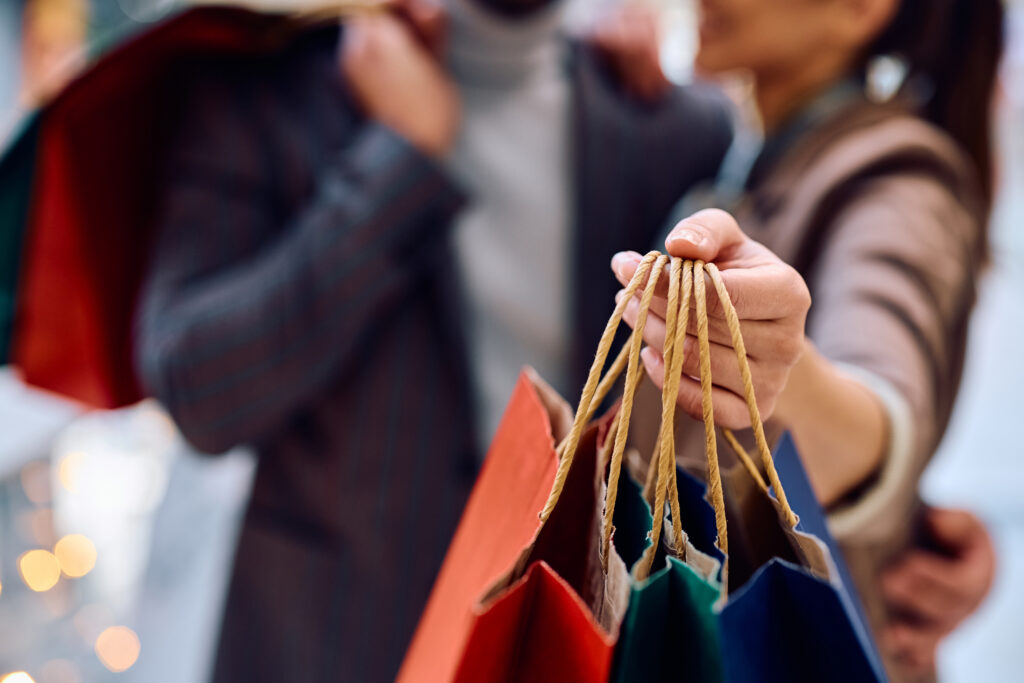 Couple handling shopping bags as a sign of buying.